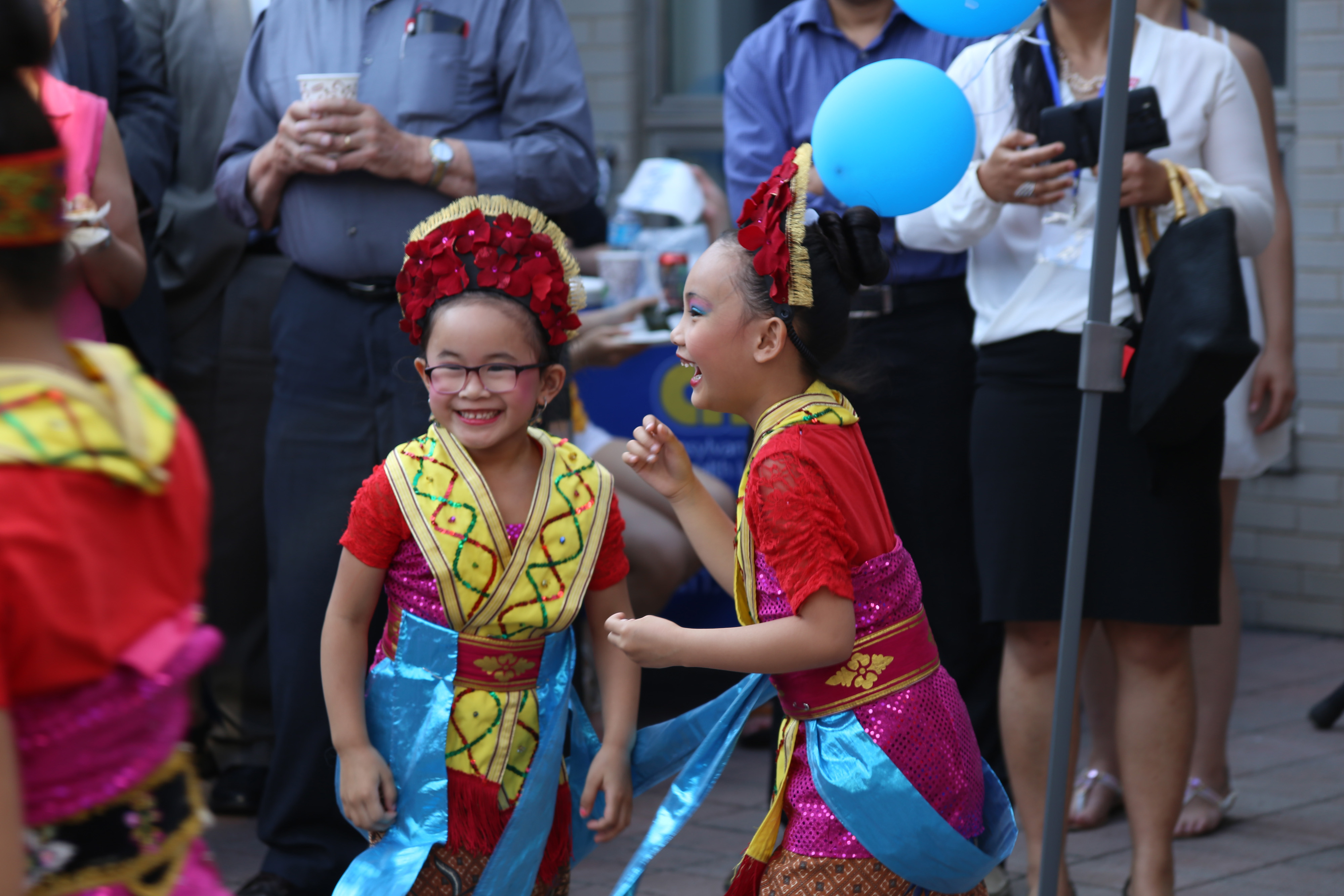 Two little girls share a moment during an Immigrant Heritage Month even in June 2016 in South Philadelphia.