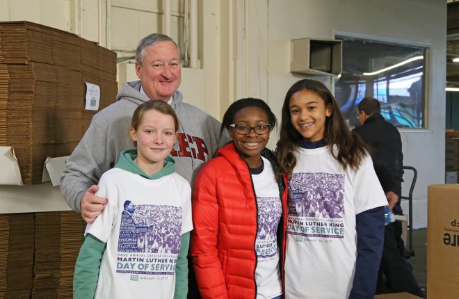 Mayor Kenney poses with volunteers who helped bagged groceries with firefighters from Engine 35 Ladder 25.
