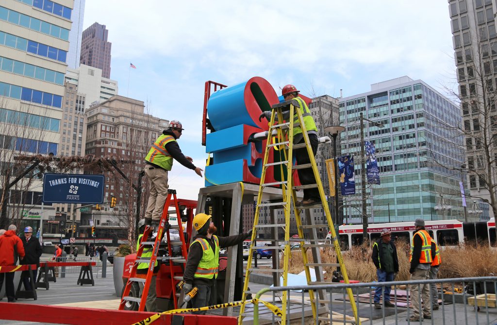 Crews work to temporarily move the LOVE sculpture for conservation, on February 15, before its return to LOVE Park.
