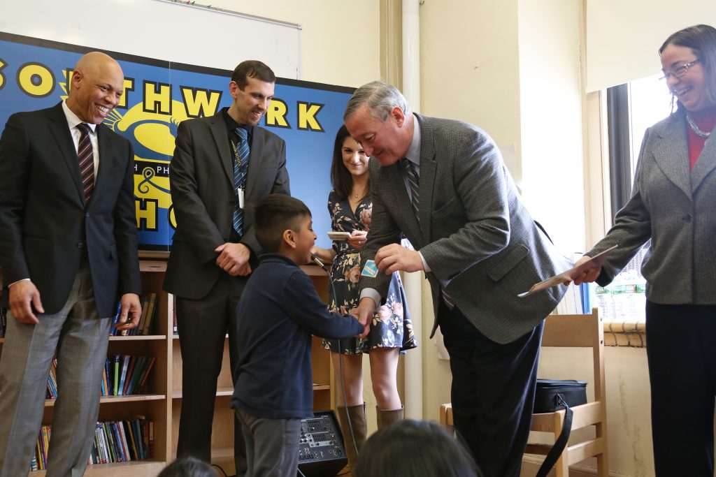 Mayor Kenney helps distribute library cards to Kindergarten students at Southwark School, one of the first nine community schools.