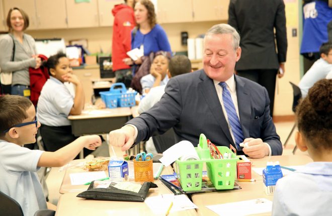 Mayor Kenney fist pumps at student at H.A. Brown Elementary School during his for National School Breakfast Week.