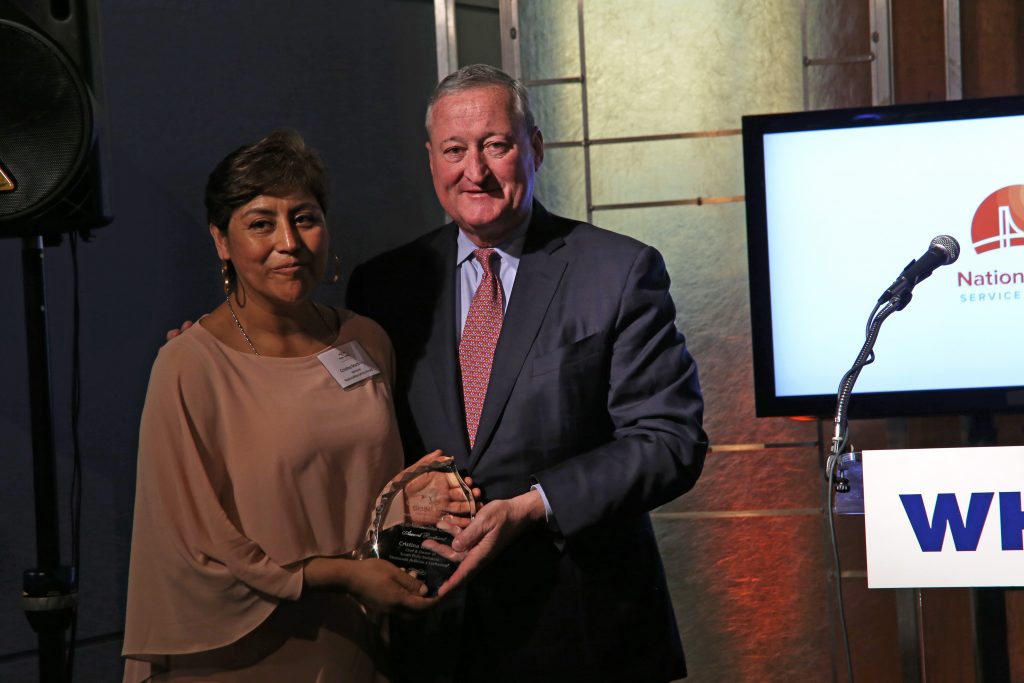 Mayor Kenney presents immigrant rights activist and noted restaurateur Cristina Martinez with the Nationalities Service Center Award.
