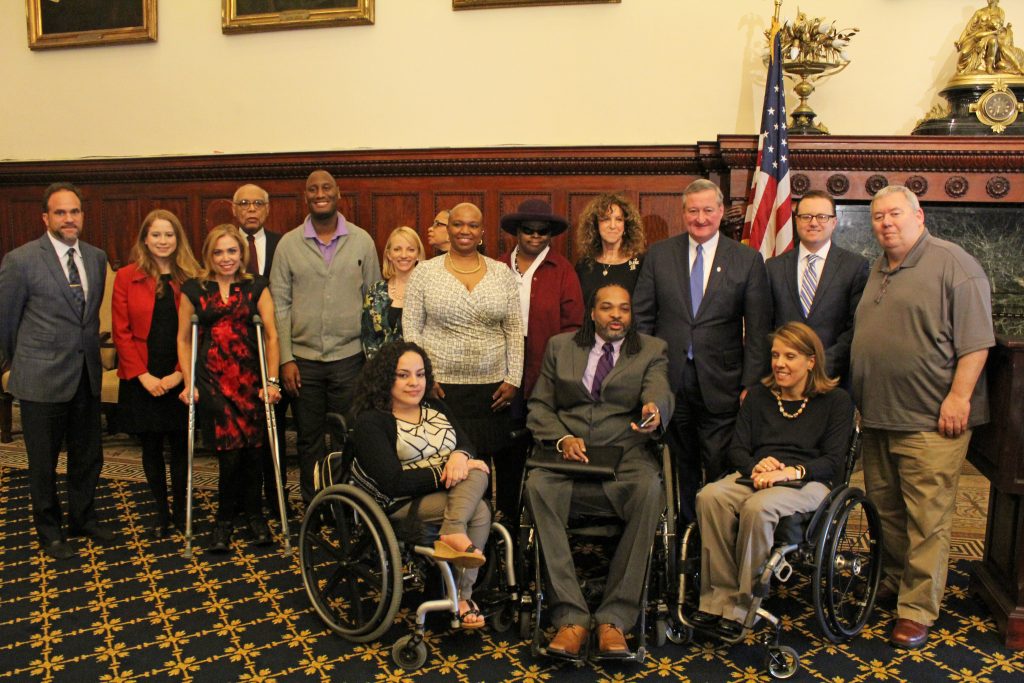 Mayor Kenney stands with the Commission on People with Disabilities in the Mayor's Reception Room at City Hall.