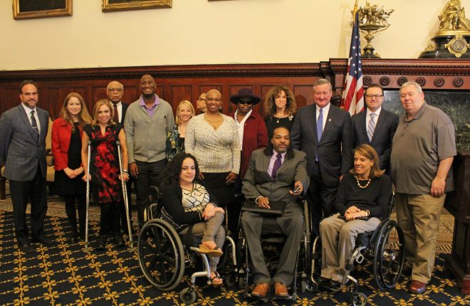 Mayor Kenney stands with the Commission on People with Disabilities in the Mayor's Reception Room at City Hall.