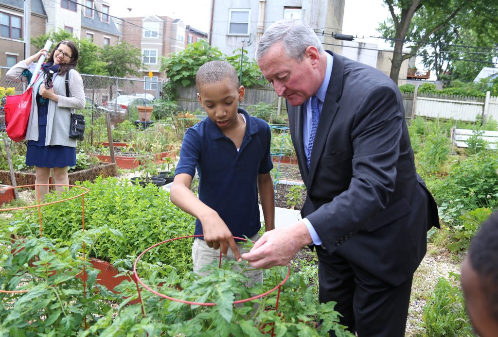 Students from E.M. Stanton Elementary School show Mayor Kenney their community garden.