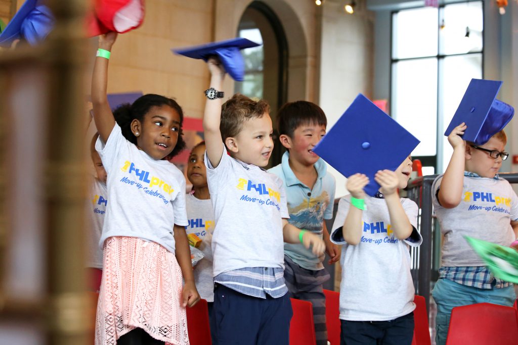 PHLpreK students who have completed pre-K and are heading to Kindergarten wave their caps at the PHLpreK Move Up Day