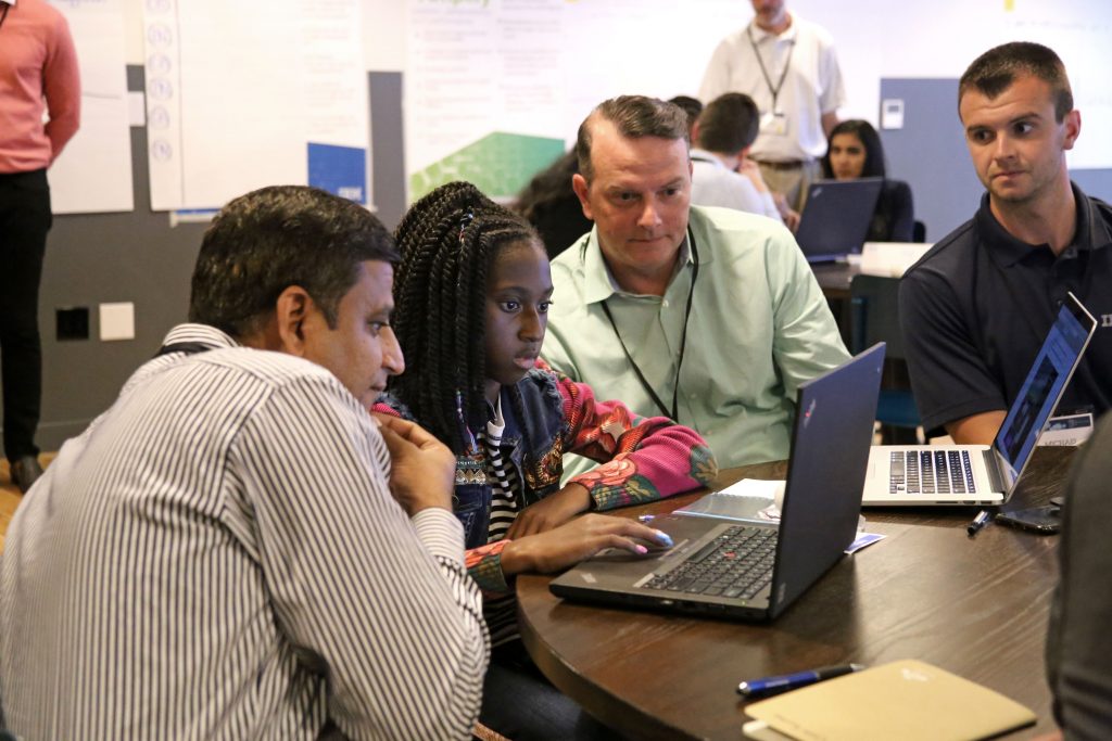 IBM employees teach coding to a Philadelphia student during the launch of a new partnership 