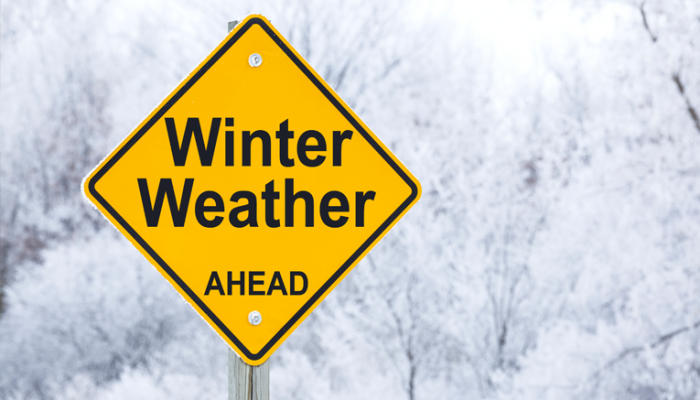 a street sign that says winter weather ahead