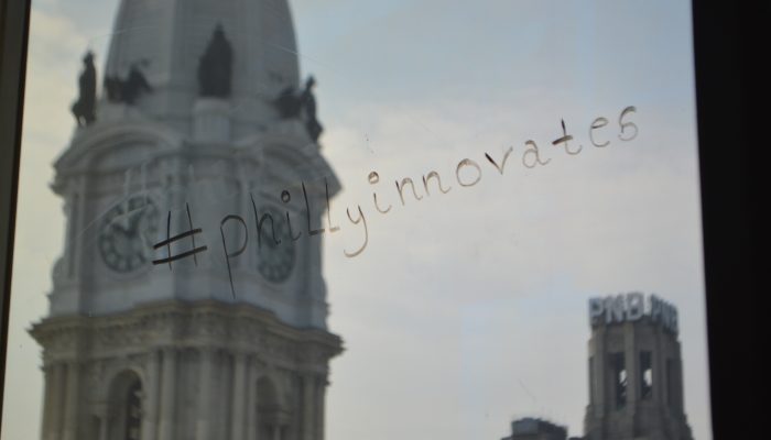 #phillyinnovates written on innovation lab window in black marker.