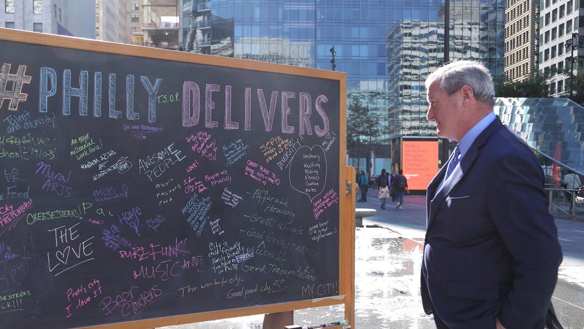 Mayor Kenney looks at a chalkboard in Dilworth Park. Dozens of different people wrote on the chalkboard why they love Philadelphia.