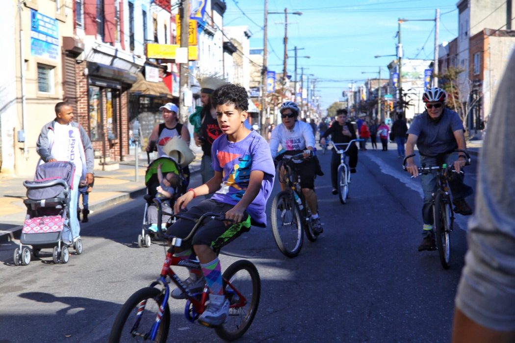 A kid rides a bike during Philly Free Streets
