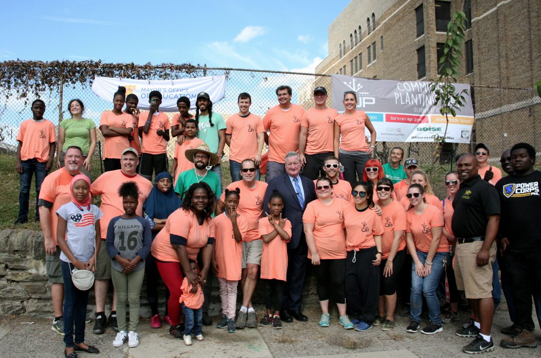 Representatives from Boise Project Up and other volunteers pose for a photo after planting trees at Tilden Middle School,