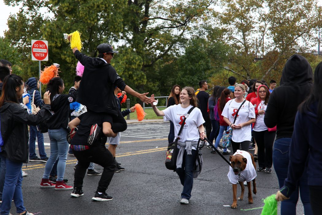 Volunteers cheer on participants during the AIDS Walk 