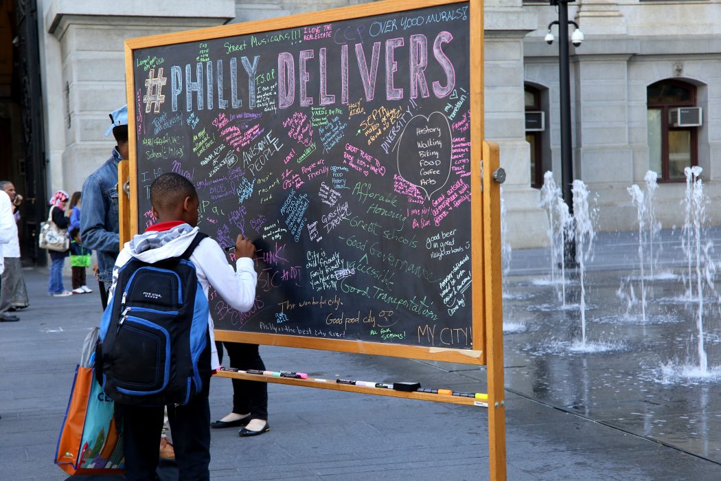 A young man shares why he loves Philly on the #PhillyDelivers chalkboard 