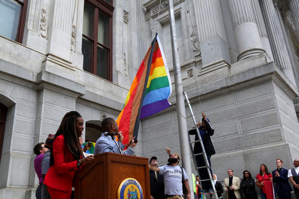 The Office of LGBT Affairs raises the redesigned Pride flag during the Pride Month Kick-Off on June 8. 