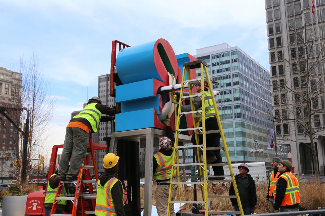 Crews work to temporarily move the LOVE sculpture for conservation on February 15. 