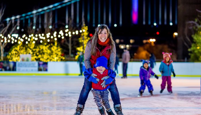 Woman and child ice skating at Winterfest.