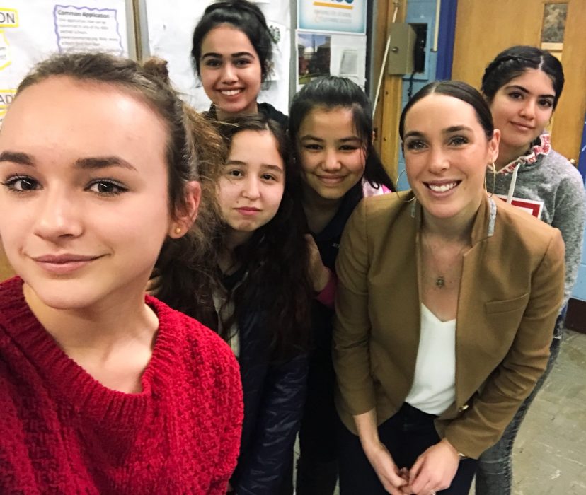 Caitlyn Boyle poses with students in the SPEAK mentorship program