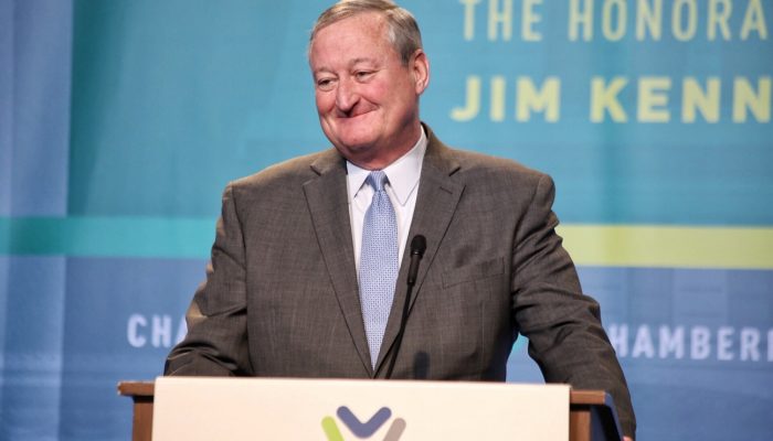 Mayor Kenney stands at a podium at the Chamber of Commerce for Greater Philadelphia's annual luncheon in 2018. He is smiling.