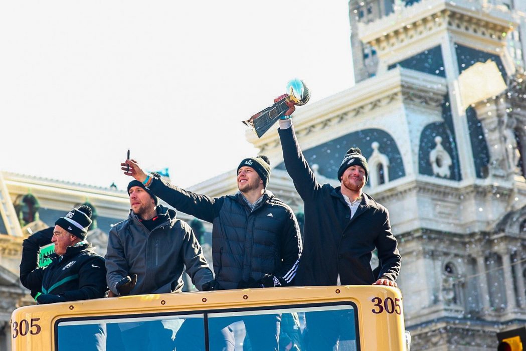 Philadelphia Eagles players ride bus along parade route