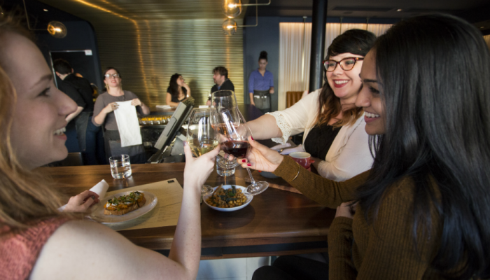 Friends enjoying wine at a restaurant in Philadelphia. Photo by C. Smyth