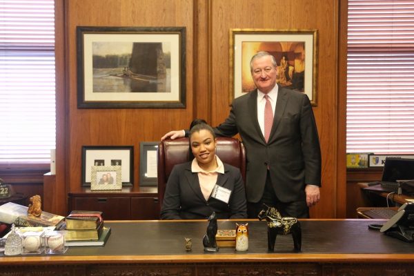 Mayor standing alongside the "PAL Mayor for the Day" in his office.