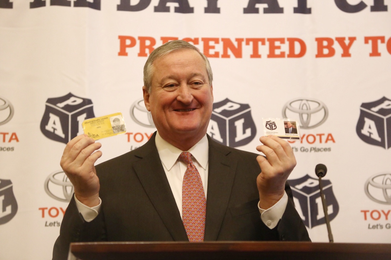 Mayor Kenney holding up his PAL identification card.