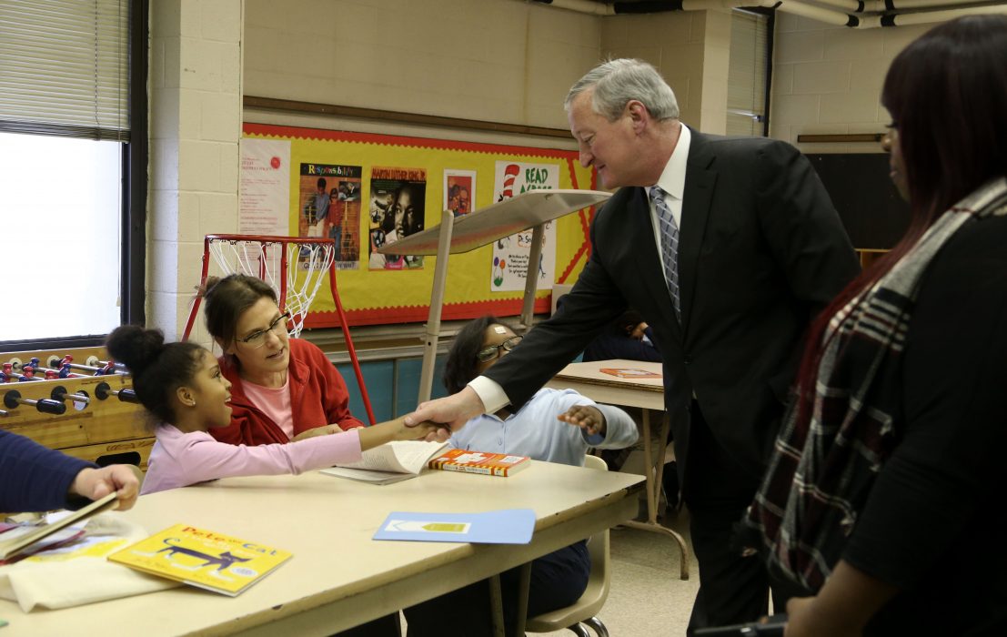 Mayor Kenney shakes the hand of a student in the Philly Reading Coaches program.