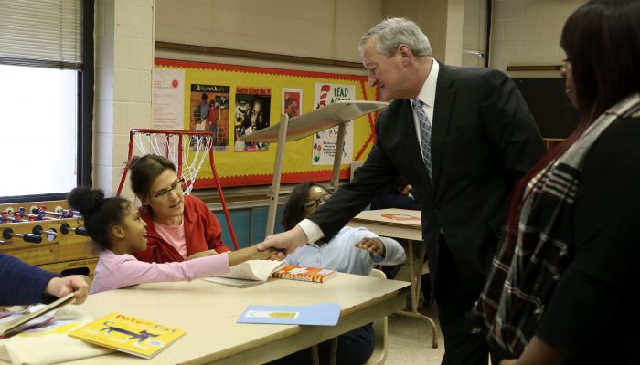 Mayor Kenney shakes the hand of a student in the Philly Reading Coaches program.