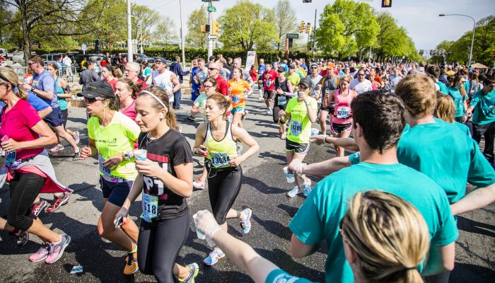 Volunteers distributing water to runners