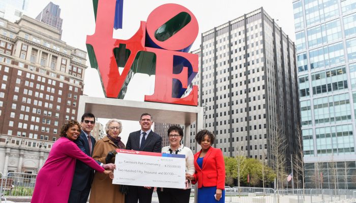 Officials pose with donation check