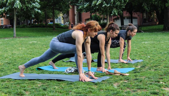 Women doing yoga in a park