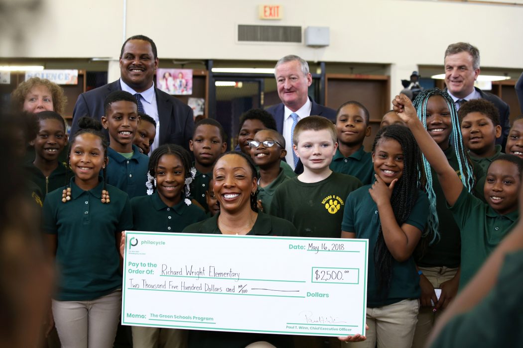 City officials pose with Richard Wright Elementary School after with the school received a check for their environmental project as part of Recyclebank’s Green Schools Program.