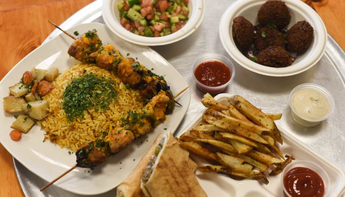 table of food with rice, sandwich, french fries, and pico de gallo