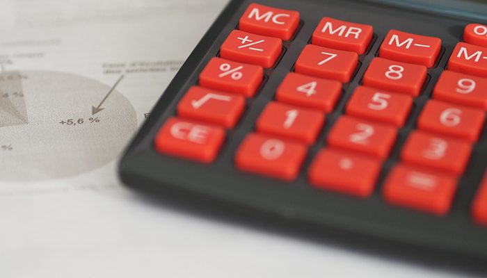 A calculator with red buttons.