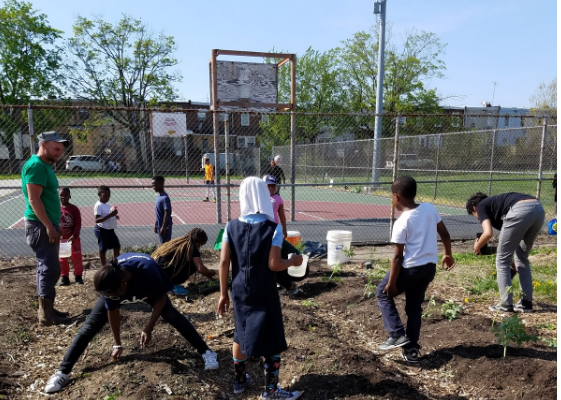 Children volunteering in a garden