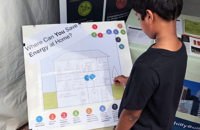 boy interacts with home energy savings activity