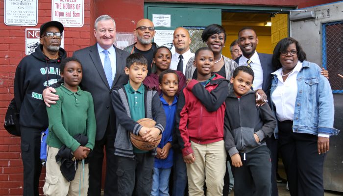 mayor kenney with a group of smiling adults and children outside Olney recreation center