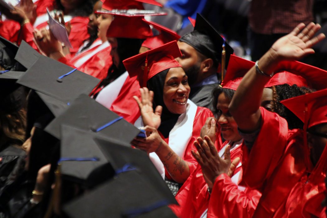A graduate waves to her family during the 4th Annual Citywide Commonwealth Secondary School Diploma (CSSD) Graduation on June 6.