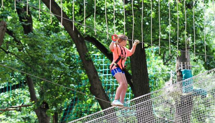 A young girl doing a ropes course