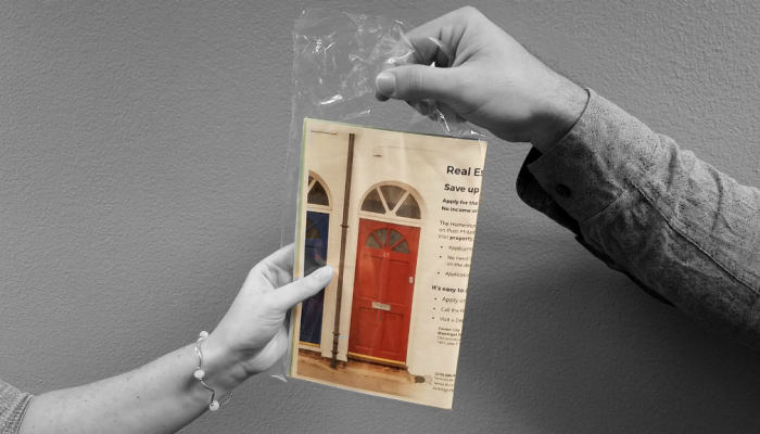 A Department of Revenue representative hands flyers about Real Estate Tax relief to a Philadelphia resident