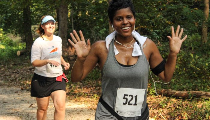 Two women running along a wooded section of the Boxers' Trail