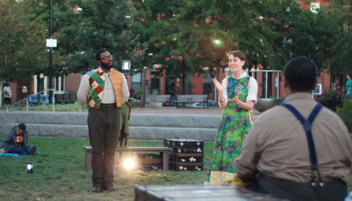 Two performers in a park