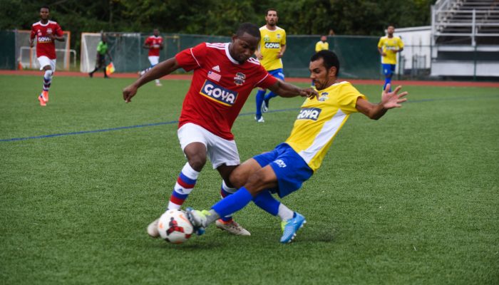 A member of team Liberia battles a Brazilian teammate for the ball