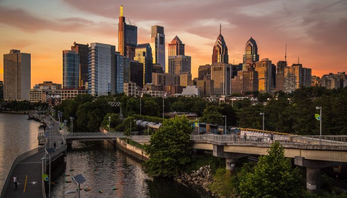 Philadelphia's skyline from the South Street Bridge with the Schuylkill River in the foreground and skyscrapers in the background.