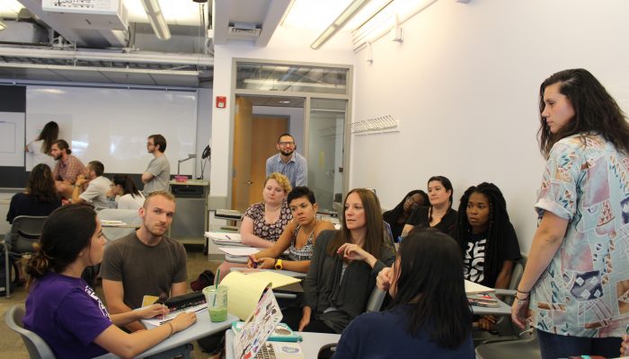 Penn Graduate School of Education intern Frances Felix sits with Penn students in a class and shares her insight