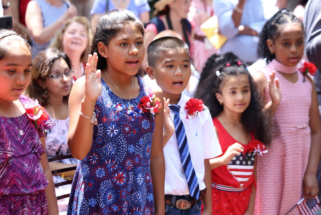 Children become citizens during a naturalization ceremony on July 4