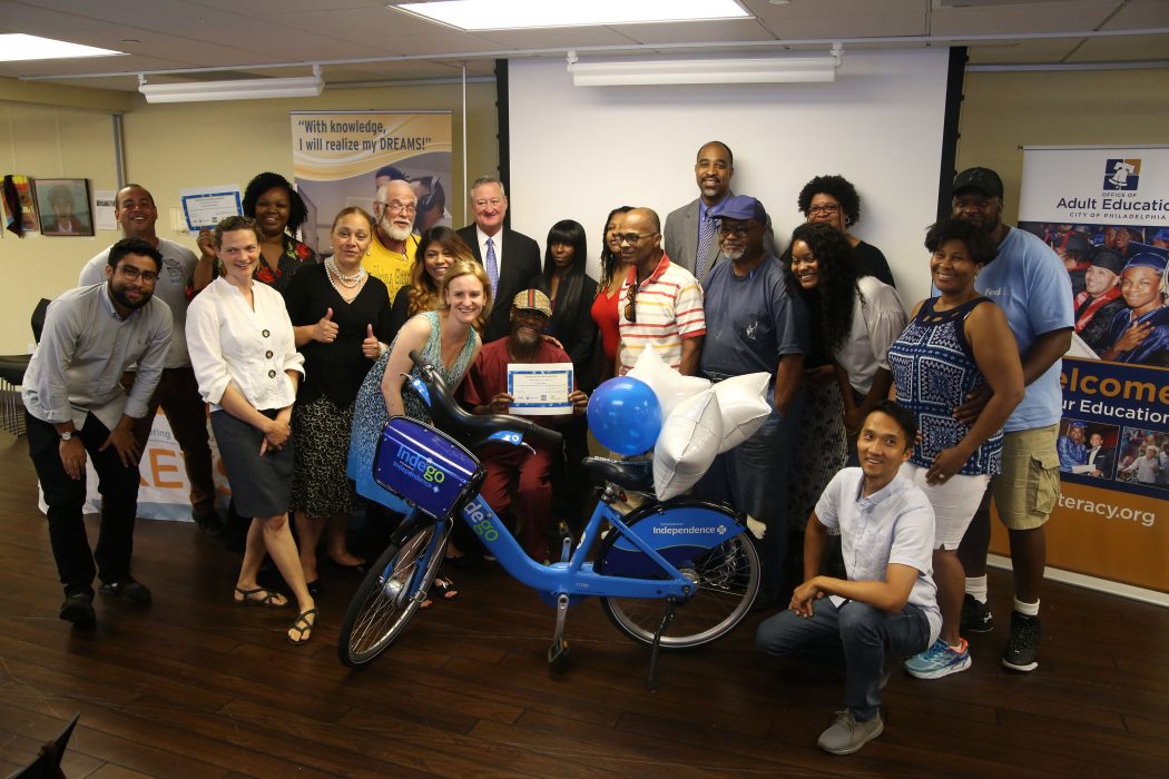 Participants of the Digital Skills & Bicycle Thrills program pose with Mayor Kenney and other officials during their graduation ceremony on July 24.