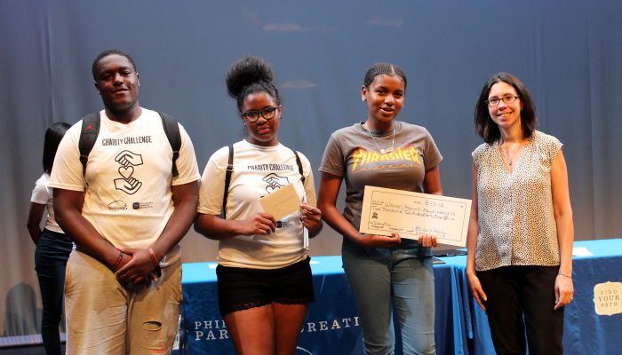 WorkReady youth award a check to Women Against Abuse