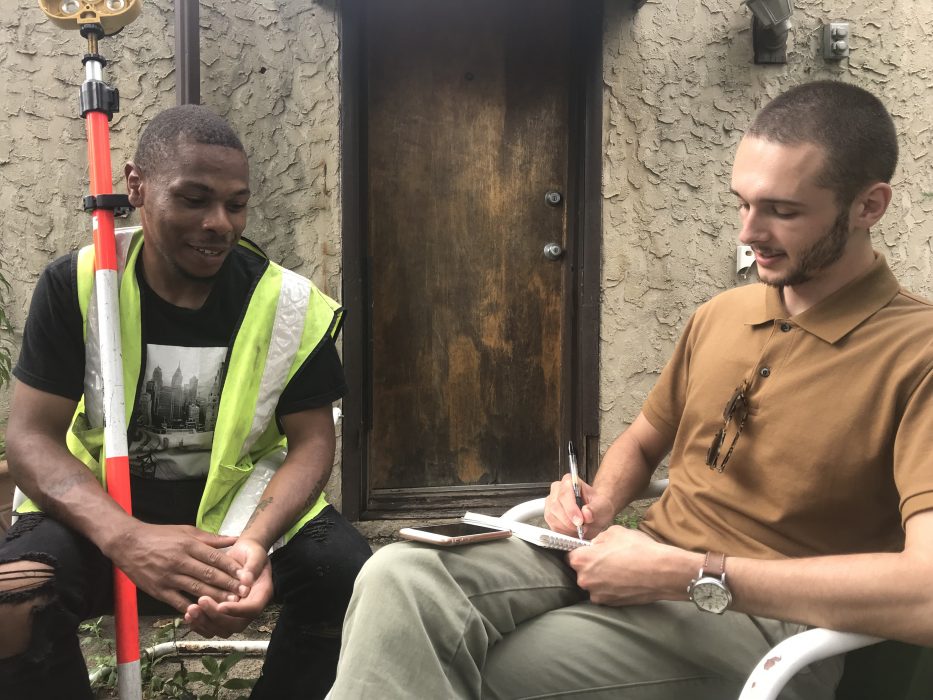 Mayor’s Office of Education intern John Harris and James Burtin from the Streets internship sit outside and talk about James’ experiences